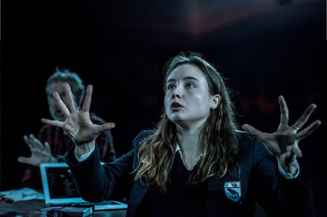 An actress in a school uniform on stage