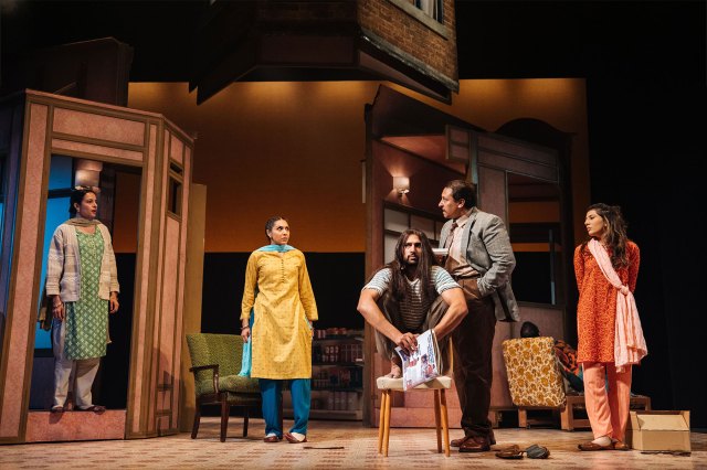 Un groupe de cinq acteurs, trois portant des costumes sud-asiatiques, se sont réunis sur un salon set sur scène